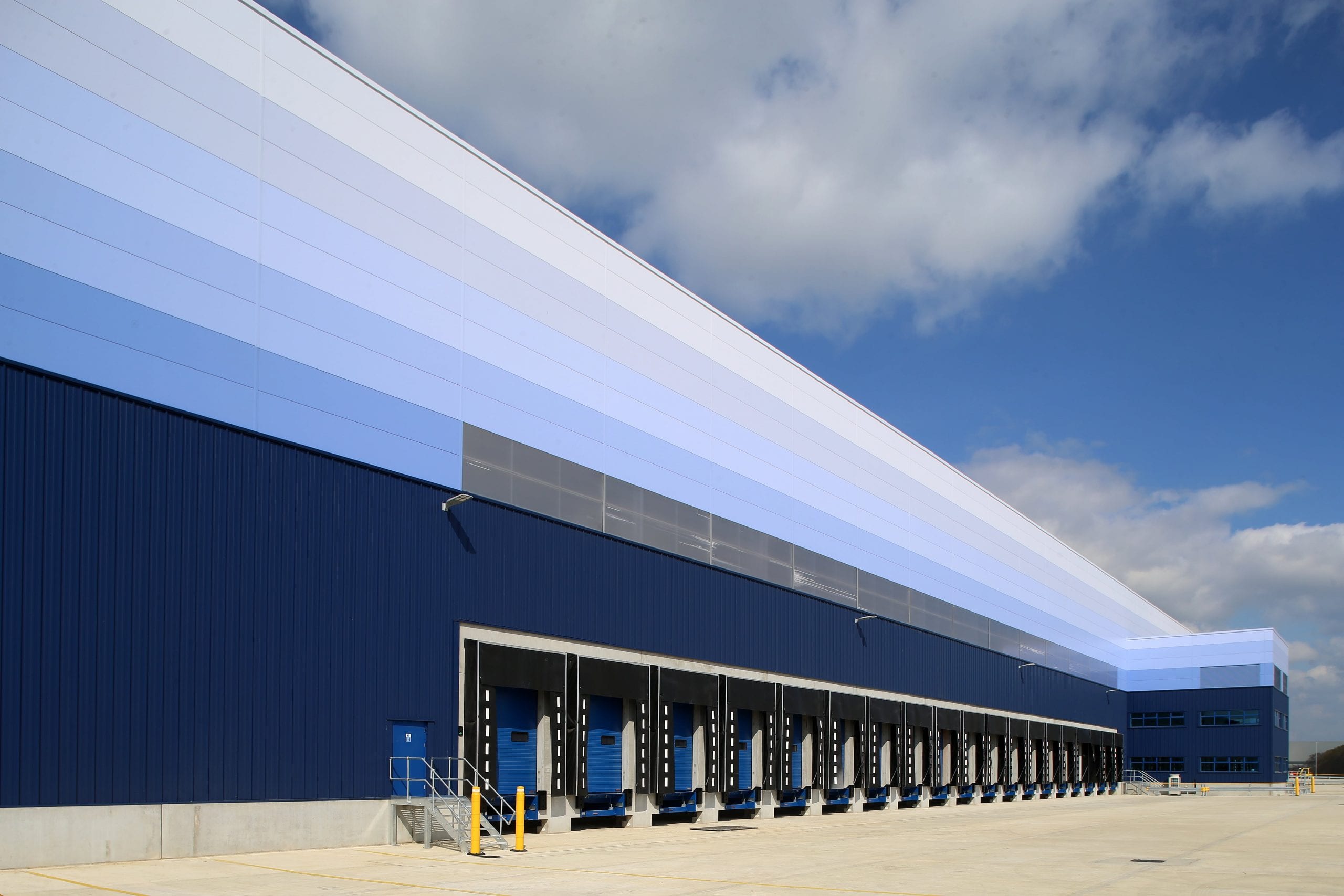 GLP logistics centre in Doncaster showing blue and white colour scheme of exterior walls and multiple empty loading bays.