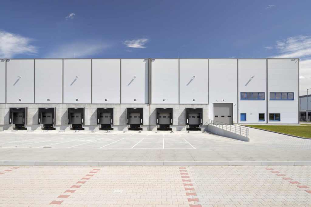 Exterior of GLP Wroclaw IV Logistics Centre showing multiple loading bays labelled with numbers.