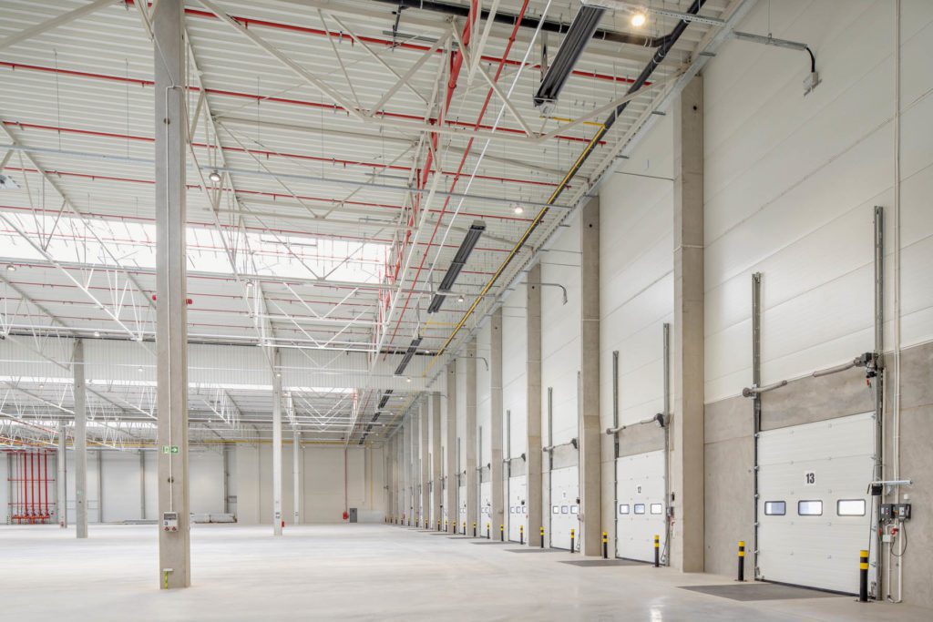 Interior of Wroclaw IV logistics centre showing rows of loading bays labelled with numbers.