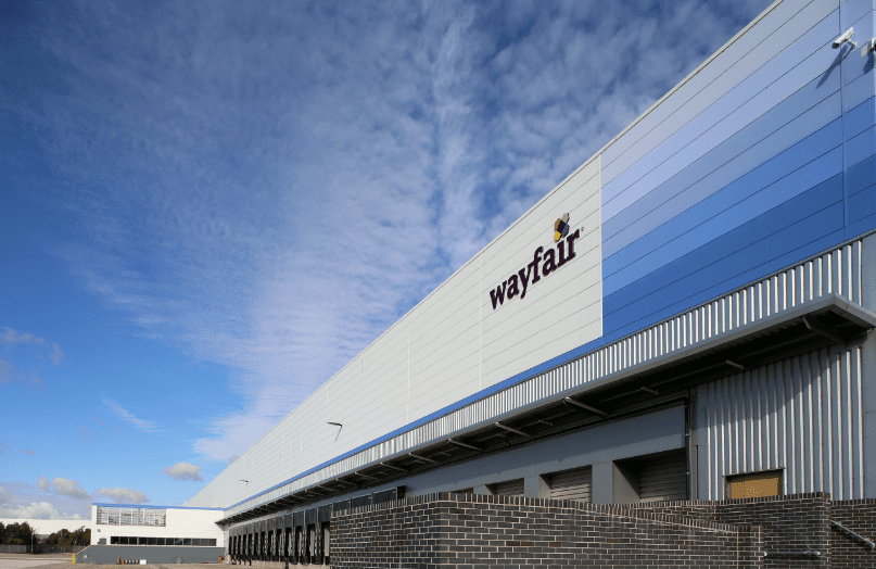 GLP Logistics Centre under a cloudy sky, with a blue colour scheme and branded letters that read wayfair installed onto the outside wall.