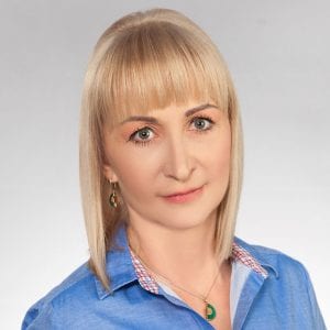 Headshot of Magdalena Warzynska with short blonde hair, wearing a blue shirt.