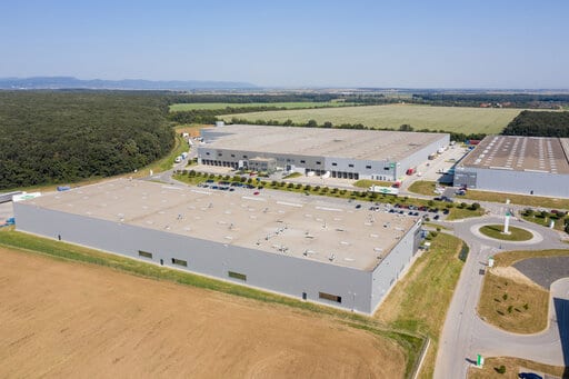 Bratislava Senec Logistic Centre from a distance, showing three large warehouse structures, connecting roads and empty land in development