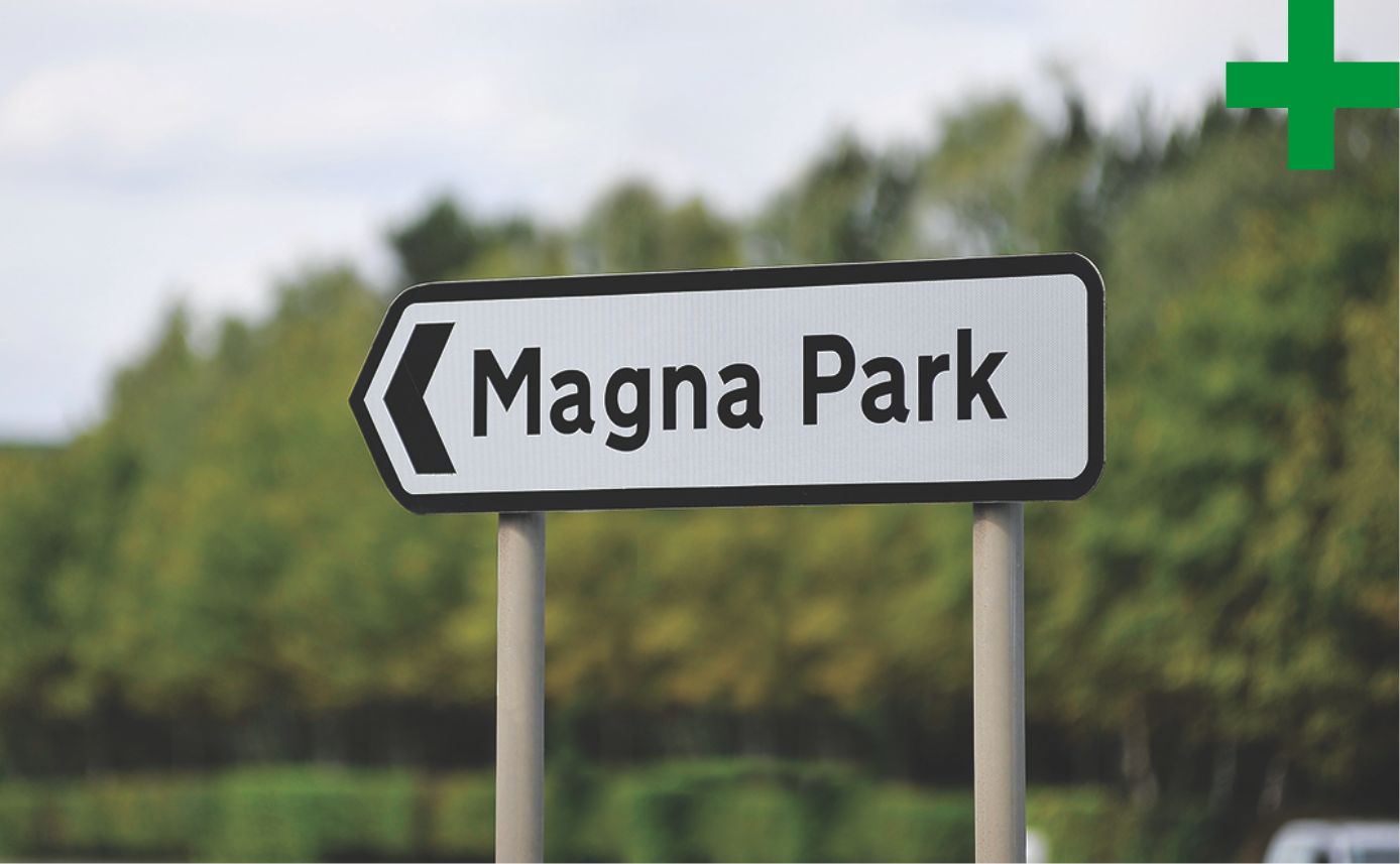 British road sign that points to the left and reads Magna Part