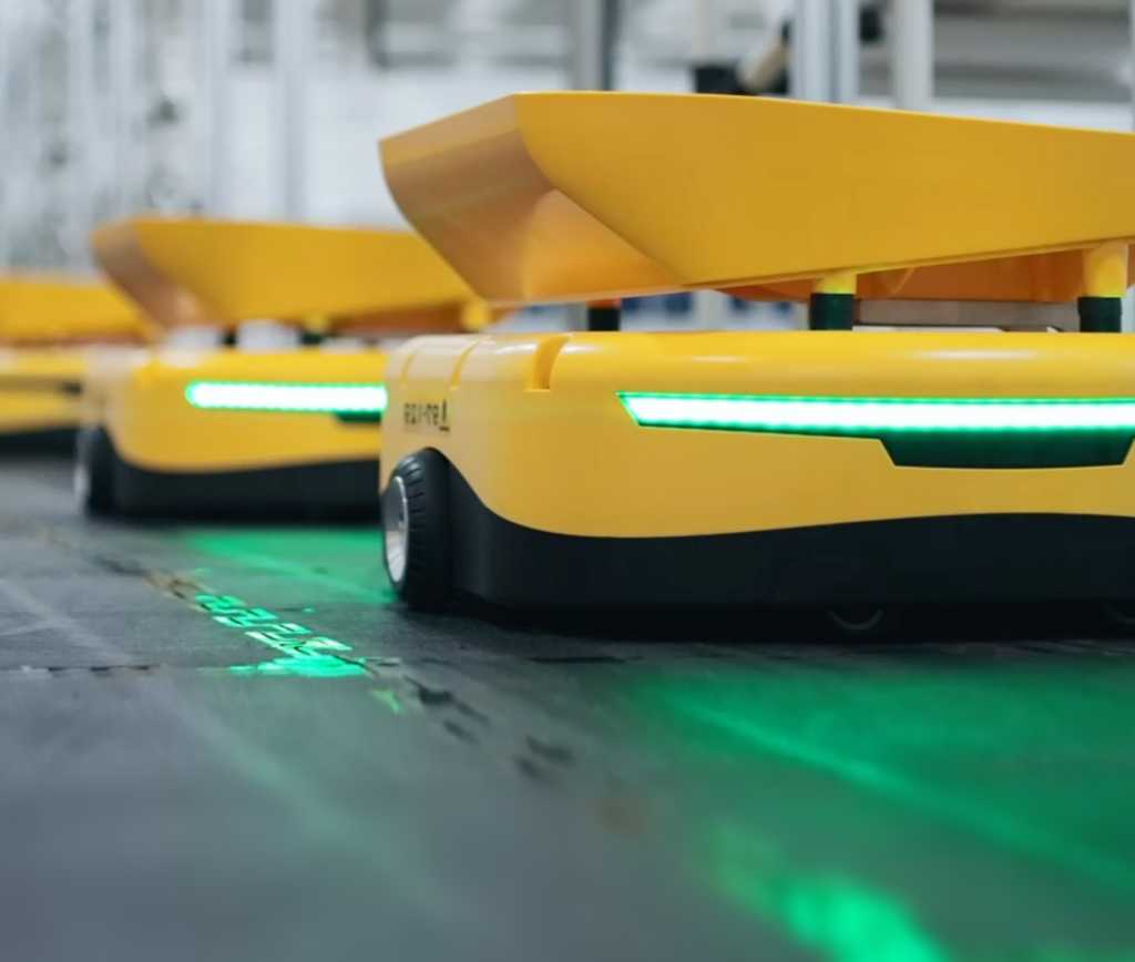 Small yellow sorting robots being used in warehouse operations sitting in a row