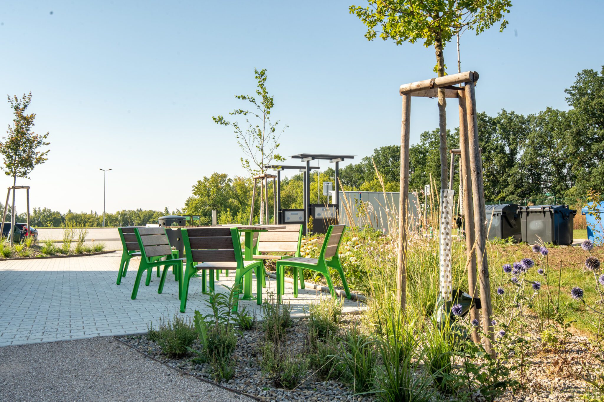 Seating area outside of a GLP warehouse with greenery, a green oasis outside of an industrial zone.